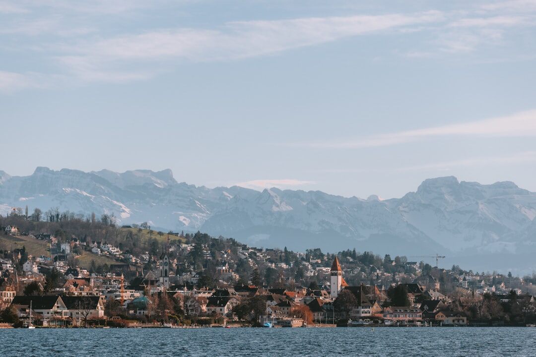 Zurich city skyline at dusk with lake and mountains