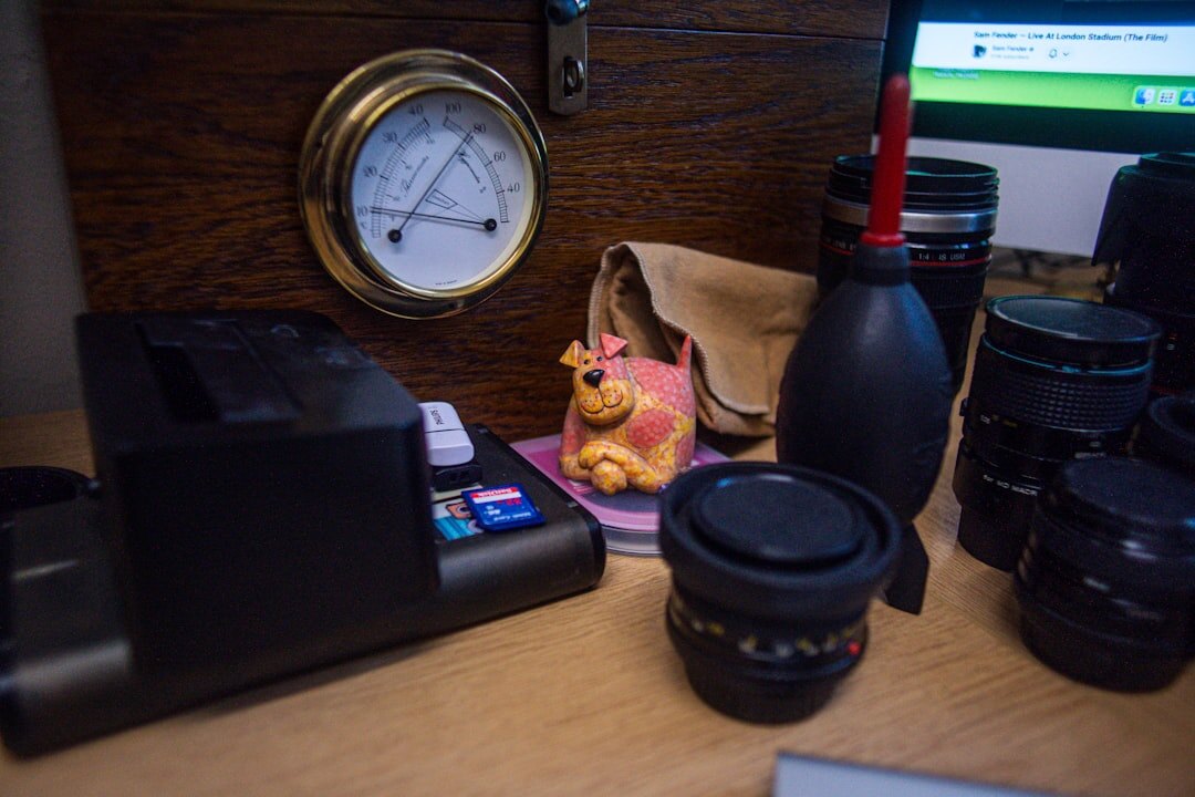 Stack of newspapers with a vintage camera and press pass on a wooden desk